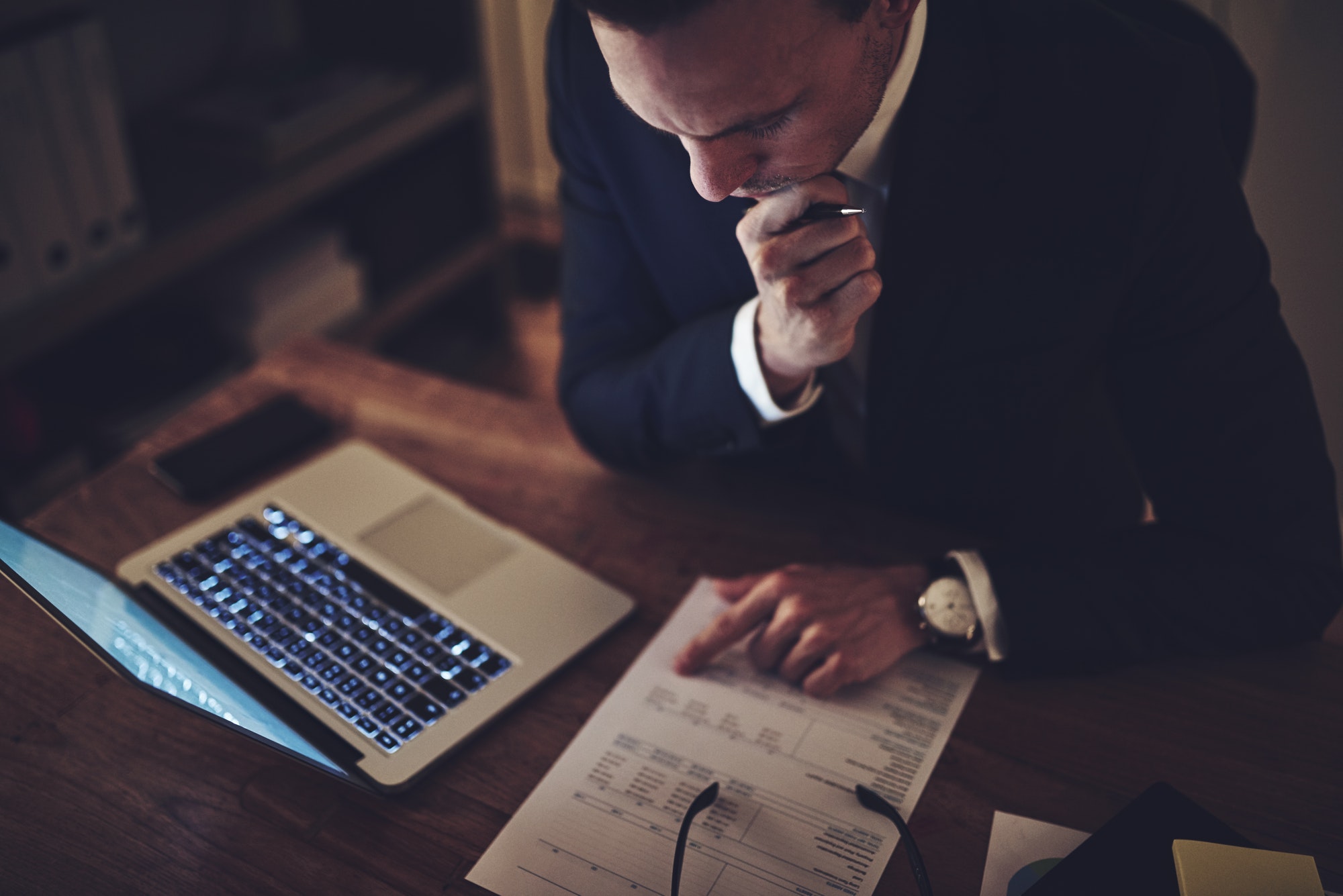Pensive accountant at the workplace at night.jpg